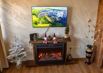 a fireplace in a living room with a painting above it at Bansko home with a Mountain view in Bansko