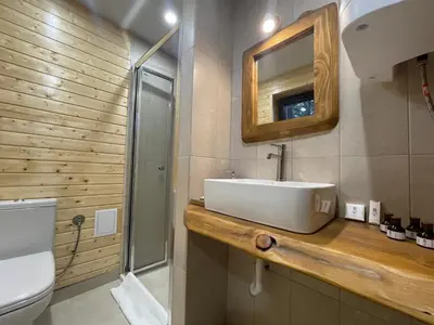 a bathroom with a sink and a toilet and a mirror at Boro Green Holiday Village in Borovets