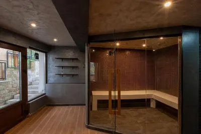a bathroom with a shower with a glass door at Къща за гости Пилигрим in Skrino