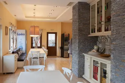 a kitchen and living room with a brick wall at Къща за гости Пилигрим in Skrino