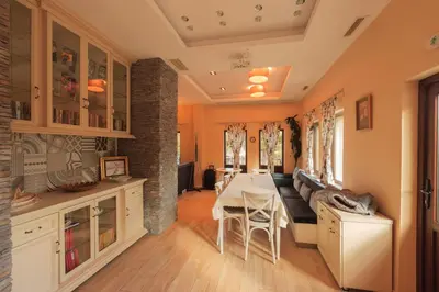 a kitchen and dining room with a table and chairs at Къща за гости Пилигрим in Skrino