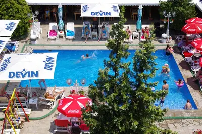 a large swimming pool with people in the water at Complex Diana in Cherven
