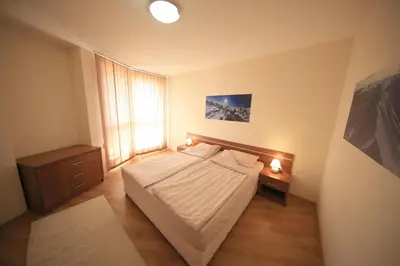 a small bedroom with a bed and a window at Nice and quiet apartment next to Gondola lift. in Bansko