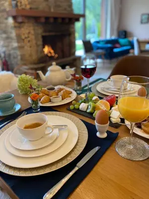 a table with plates and cups of coffee and food at Luxury Chalet & Spa Tia Maria with Private SPA in Bansko