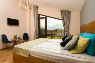 a bedroom with a large bed with a large window at Luxury Chalet & Spa Tia Maria with Private SPA in Bansko