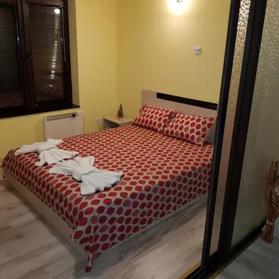 a bedroom with a bed with towels on it at Guest House Ileana in Sapareva Banya