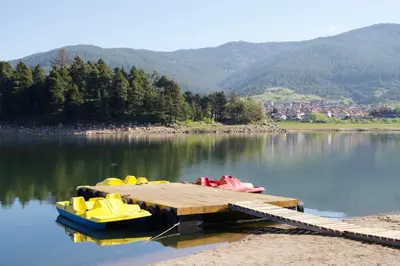 a dock with four boats sitting on a lake at VIP Complex in Sarnitsa