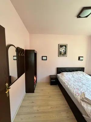 a bedroom with a bed and a wooden floor at VIP Complex in Sarnitsa