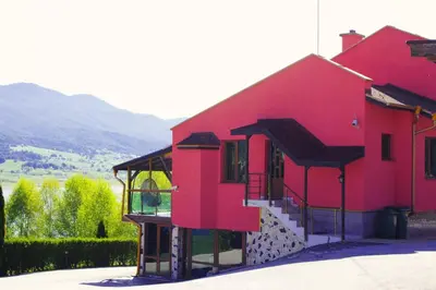 a red building with a staircase in front of it at VIP Complex in Sarnitsa