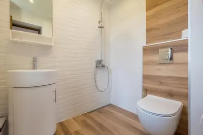 a bathroom with a toilet and a sink and a shower at Villa ADELHEIDE - Spa, BBQ & Jacuzzi in Beli Iskar
