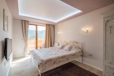 a bedroom with a bed and a large window at Villa ADELHEIDE - Spa, BBQ & Jacuzzi in Beli Iskar