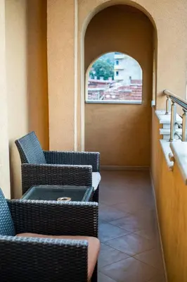 two wicker chairs sitting in a room with a window at Sky Garden House in Velingrad