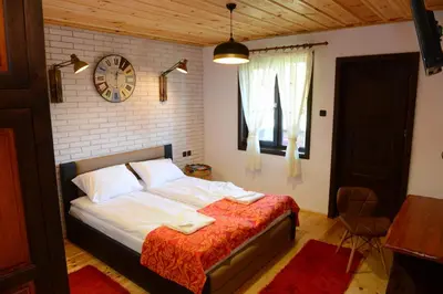 a bedroom with a bed and a clock on the wall at Dream house in Leshten