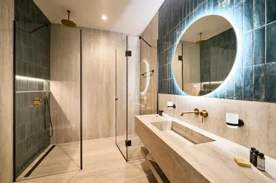 a bathroom with a sink and a shower and a mirror at Adella Boutique Hotel - Free Secured Parking in Sofia