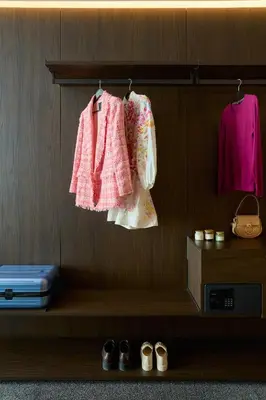a shelf with two dresses and shoes and a suitcase at Adella Boutique Hotel - Free Secured Parking in Sofia