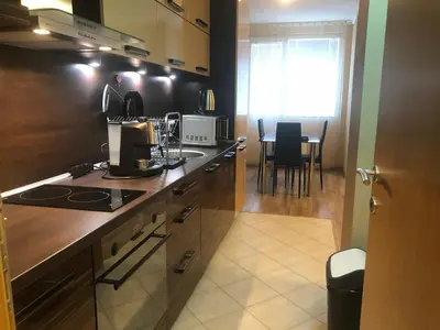 a kitchen with a counter top and a table with chairs at Rakovski Apartment GN / FREE GARAGE in Sofia