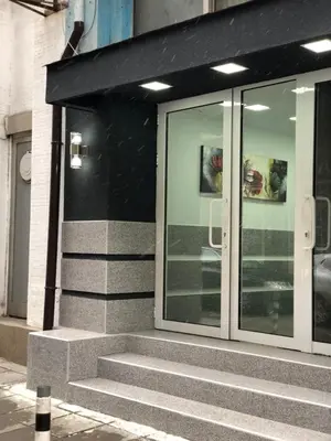a glass door of a building with stairs in front at Cosy House in Sofia
