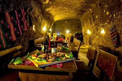 a table with a plate of food in a tunnel at Hotel Melnik Хотел Мелник in Melnik