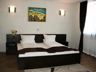 a bedroom with a large bed in a room at Hotel Melnik Хотел Мелник in Melnik