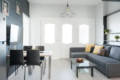 a living room with a couch and a table at Vitosha Blvd - 2BR LUX APART in Sofia