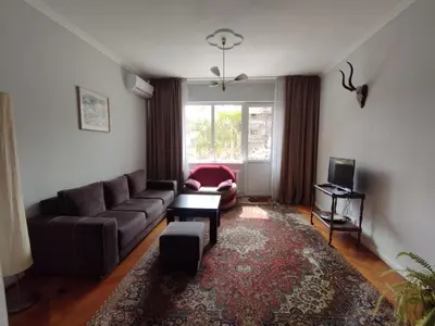 a living room with a couch and a tv at Top Center Apartment 7 in Sofia