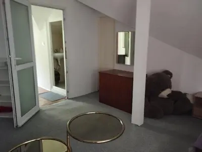 a teddy bear sitting on the floor in a room at Tolem in Borino