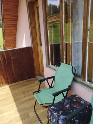 a green chair sitting on the porch of a house at Tolem in Borino