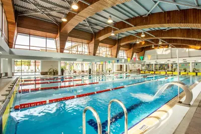 a large indoor swimming pool with blue water at Kamengrad Hotel & SPA in Panagyurishte
