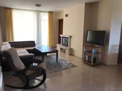 a living room with a couch and a television at Apartment Lucy in Pamporovo