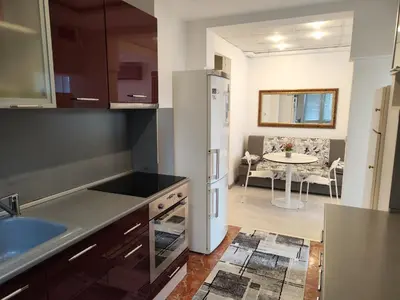 a kitchen with a white refrigerator and a table at Стаи за гости Ве-Бо-Ли** in Bankya
