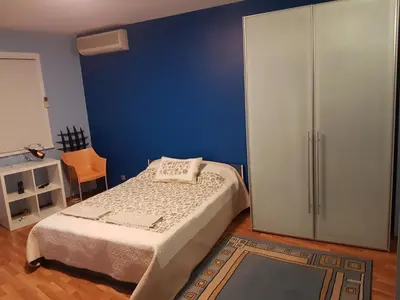 a bedroom with a bed and a blue wall at blue room in Sofia