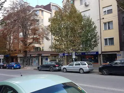 a street with cars parked on the side of the road at blue room in Sofia