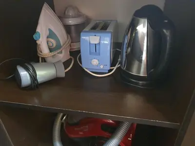 a wooden shelf with acomputer and a appliance on it at Koko's apartments in Bansko