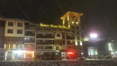 a building with a sign on it in the snow at Koko's apartments in Bansko