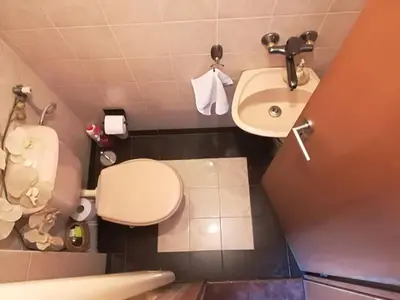 a small bathroom with a toilet and a sink at Cosy, quiet house with Vitosha view near Paradise in Sofia