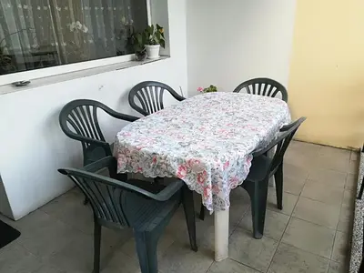 a table with four chairs with a floral table cloth at Cosy, quiet house with Vitosha view near Paradise in Sofia