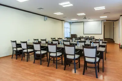 a conference room with a long table and chairs at Hotel Domaine Peshtera in Peshtera
