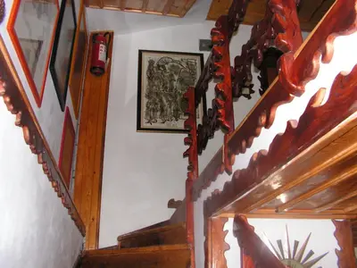 a stairway with wooden stairs and a picture on the wall at Семеен хотел Калина Family hotel Kalina Говедарци in Govedartsi