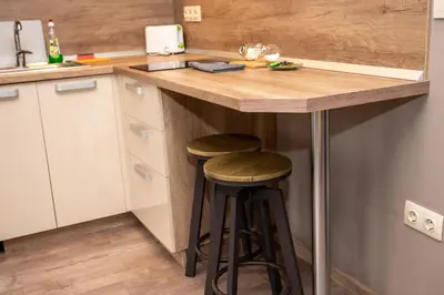 a kitchen with two bar stools at a counter at All Seasons Apartments Iglika 2 in Borovets