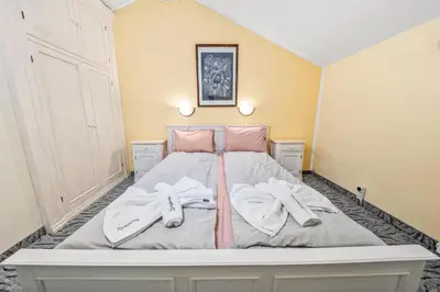 a bedroom with a bed with two towels on it at House Shiligarnika in Bansko