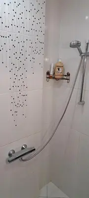 a bathroom with a shower with a shower curtain at Modern and Old Base in Sofia