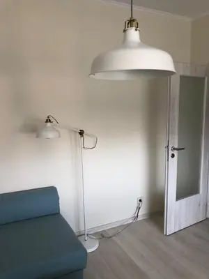 a living room with a blue couch and a lamp at Apartment 