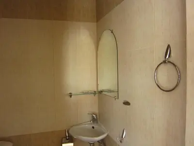 a bathroom with a sink and a mirror at Family Hotel Bistritsa in Sandanski