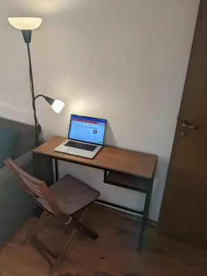 a laptop computer sitting on a desk next to a lamp at Casual Apartment near Gondola & City Center - Neon in Bansko