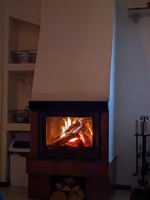 a fireplace with a fire in it in a room at Casual Apartment near Gondola & City Center - Neon in Bansko