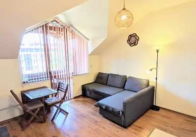 a living room with a couch and a table at Casual Apartment near Gondola & City Center - Neon in Bansko