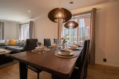 a dining room with a large wooden table with chairs at Hyggemate - 2 Bed Room Warm Stay in Sarnitsa in Sarnitsa