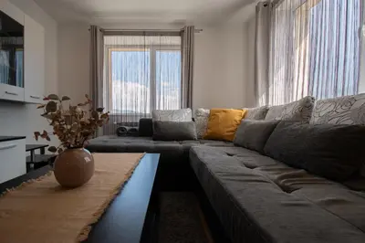 a living room with a couch and a table at Hyggemate - 2 Bed Room Warm Stay in Sarnitsa in Sarnitsa