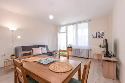 a living room with a wooden table and a couch at Atacama - spacious apartment in Lozenets area by Flat Mаnager by Flat Mаnager in Sofia