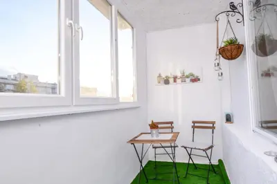 a room with two chairs and a table with a green rug at Atacama - spacious apartment in Lozenets area by Flat Mаnager by Flat Mаnager in Sofia